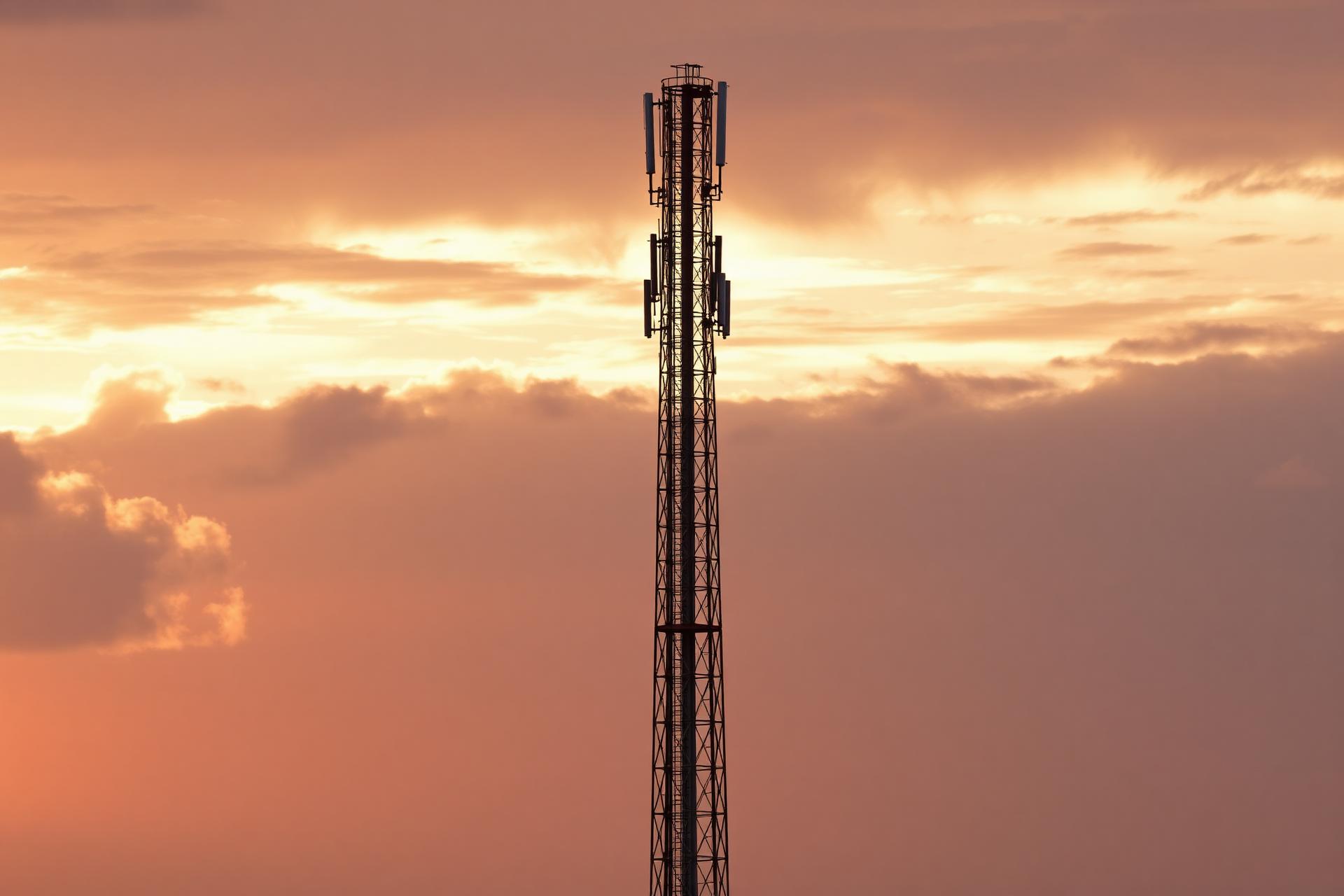 Telecom tower against golden hour sky